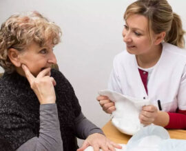 Healthcare professional assisting patient in clinical setting
